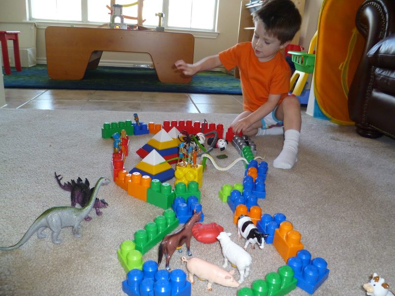 Toddler playing with toys on the ground in a daycare centre