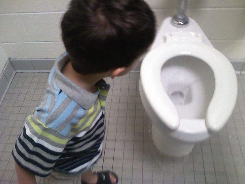 Boy staring at toilet